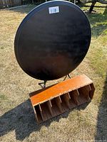 Front of round table standing upright with wooden organizer placed below
