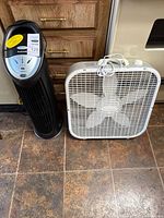 Honeywell tower fan beside Lasko 20" box fan