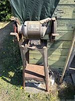 Full view of bench grinder mounted on pedestal