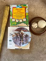 Group shot showing bat, encyclopedia set, plate in box, frame, two baseballs