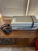 Stacked Liteon DVD recorder on top of SV2000 VCR/DVD combo with infrared headphones beside