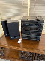 Full lot view showing main unit, two speakers, remote