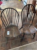 Two wooden Windsor-style chairs side by side