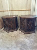Pair of hexagon side tables front view showing carved doors