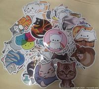 Pile of assorted cat meme vinyl stickers