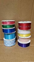 Two vertical stacks showing all ten ribbon spools in various colors