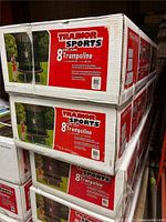 Stacked sealed cartons showing Trainor Sports 8' Trampoline branding