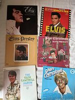Top and middle rows show four Elvis Presley albums; bottom row shows two Glen Campbell albums