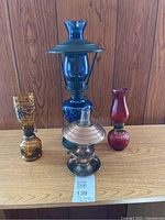 All four decorative oil lamps on shelf