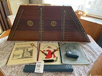 Full lot showing hammered dulcimer, books, hammers, tuner, case