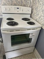 Front view showing stove top, control panel, door