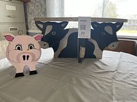 Wide view of cow shelf and pig planter together
