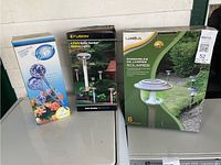 Front view of three boxed garden products