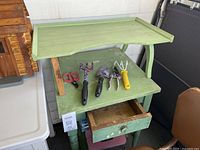 overall lot view showing washstand, garden tools on top, drawer open