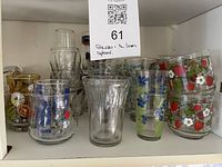 Front view of entire group of drinking glasses on shelf
