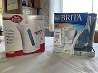 Front view of boxed Betty Crocker kettle and Brita pitcher