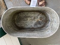 Top view of inside of metal tub showing rust and condition