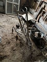 Full view of antique walking plough on barn floor