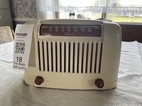 Front view of Addison Bakelite radio showing dial, grille and knobs