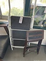 Both folding step stools shown folded against wall