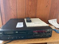 HQ VHS VCR with remote and manual on top