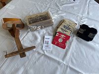 Full lot overview on table: wooden stereoscope, stereograph card stack, View-Master reels in sleeves, black View-Master viewer