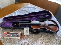 Violin, bow, case interior, boxed shoulder rest overview