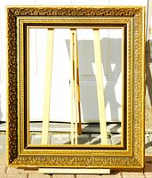 Full front view of ornate gold wood and gesso frame