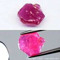 Front and back views of the rough 3.00ct pinkish red ruby held by tweezers