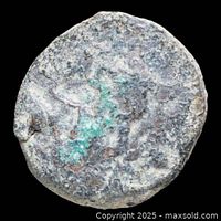 Obverse side of corroded bronze coin with green patina patches