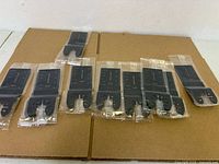 Ten sealed oscillating blades laid out on cardboard