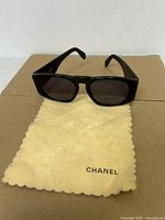 Front view of sunglasses resting on Chanel cloth