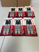 Front view of six unopened Sharpie 2-packs arranged on table