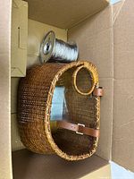 Basket, wire spool and cardboard packaging inside shipping box