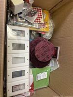 Top view of box showing wall plates, sanding discs, stickers, assorted packs