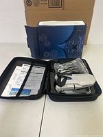 Drone kit inside carrying case with paperwork and retail box behind