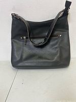 Front view of black Roots leather shoulder bag
