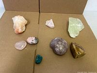 all eight stones laid out on cardboard