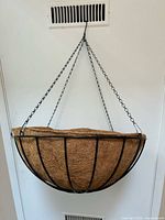 Full view of hanging basket on door showing size and chain assembly