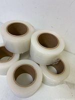 Five of the shrink wrap rolls showing clear film and cardboard cores