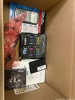 Top view showing calculator, accessory box, small black case and sticker sheet