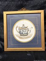 Front view of framed teapot print showing frame, mat and artwork