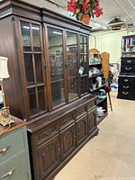 Full view of china cabinet showing upper glass display and lower storage