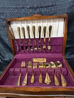 Open chest showing full flatware set