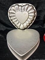 Two heart-shaped cake pans, fluted and plain