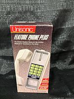 Front of boxed Unisonic Feature Phone Plus corded phone