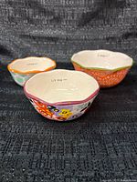 Three Pioneer Woman measuring bowls top view showing interior markings