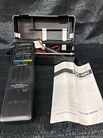 Radio, antenna, case interior, and manual overview