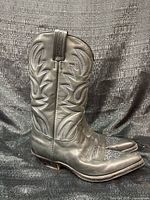 Side view of both boots showing leather, stitching pattern, soles