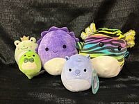 Group shot of four Squishmallows plush toys